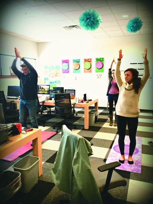 Innovation Architects at the Innovation Center take a break to practice yoga.